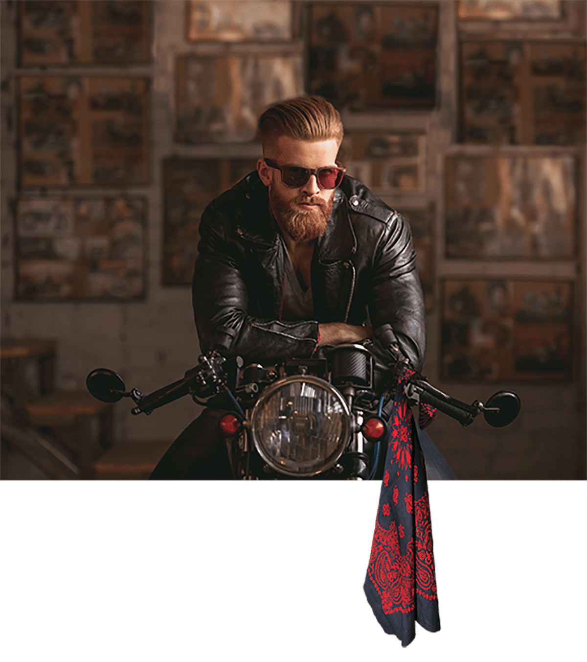 Man sitting on motorcycle holding a bandanna