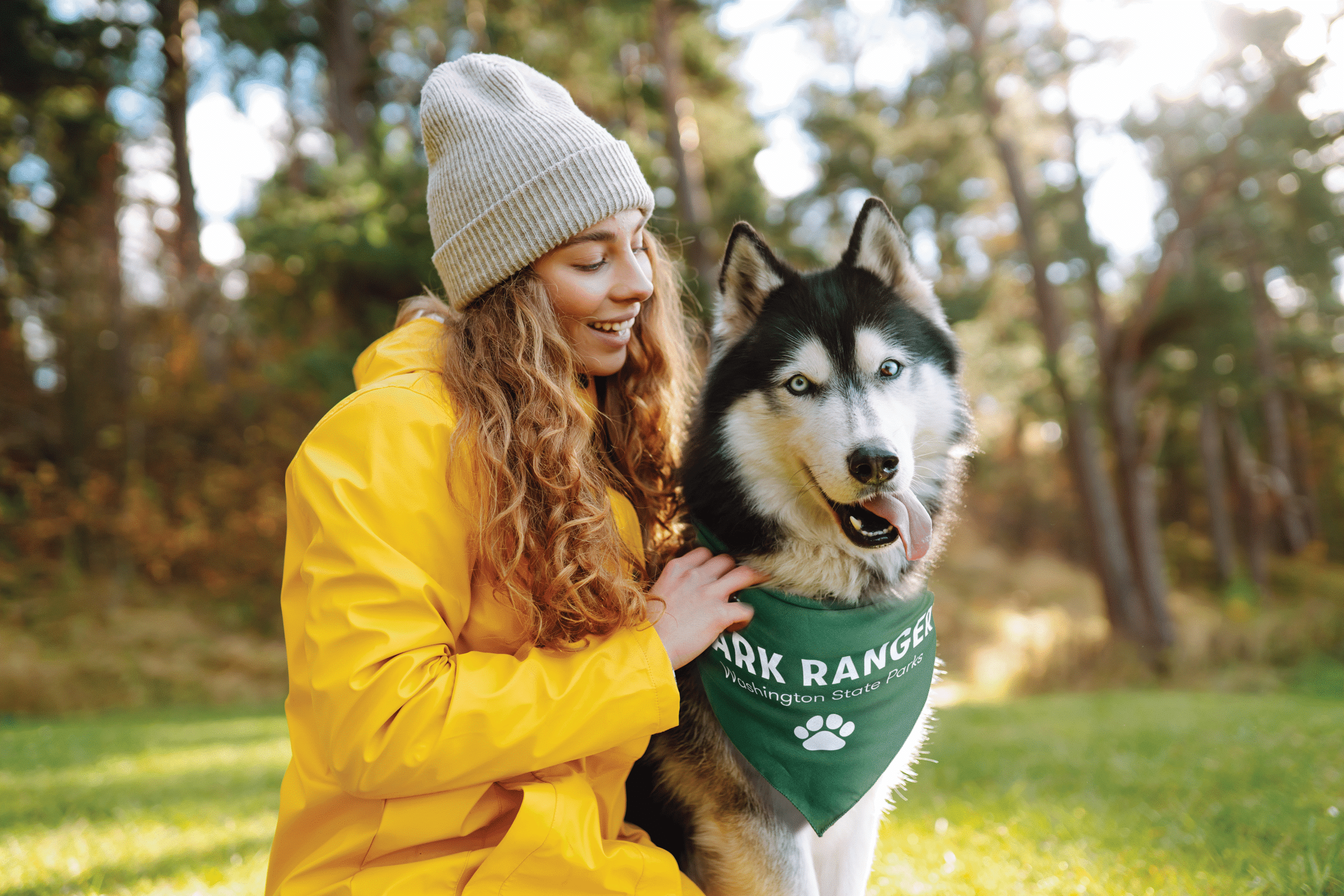 girl with husky dog wearing a bandanna