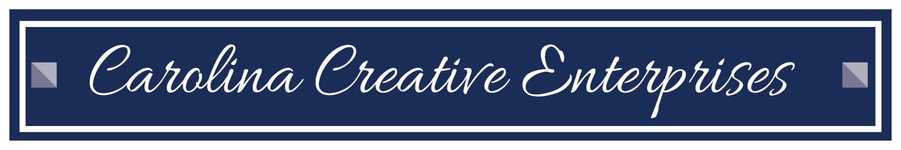A navy blue rectangular sign with a white border and cursive white text reading Carolina Creative Enterprises. Decorative gray triangles are in each corner.